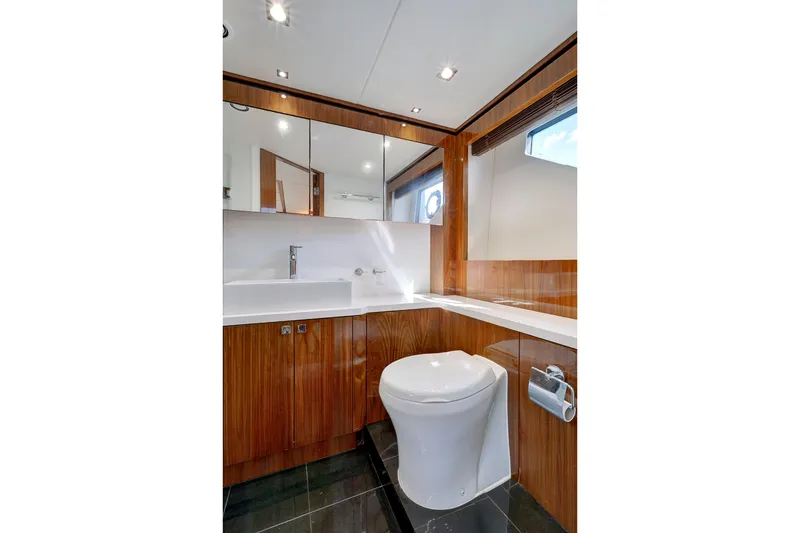 Slide: The Image of Luxurious bathroom in 2017 Sunseeker 68 Sport Yacht with modern fixtures and wood accents. - 27