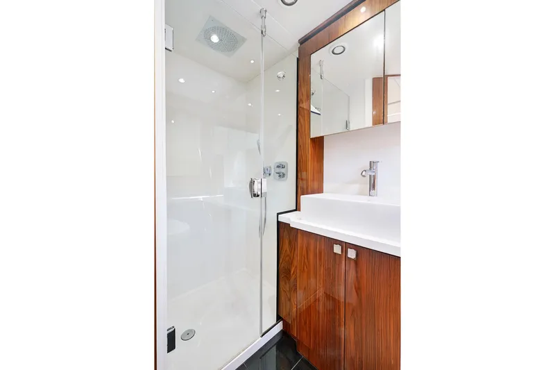 Slide: The Image of Luxurious bathroom in 2017 Sunseeker 68 Sport Yacht with modern shower and wooden cabinetry. - 28