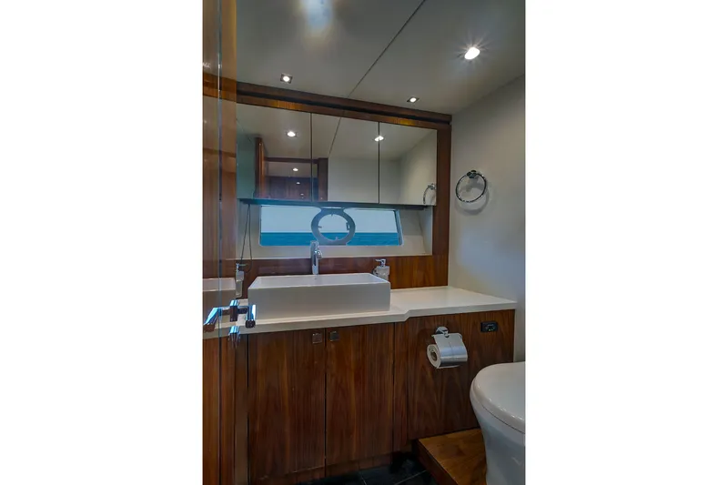 Slide: The Image of Luxurious bathroom in 2017 Sunseeker 68 Sport Yacht with modern fixtures and wood accents. - 30