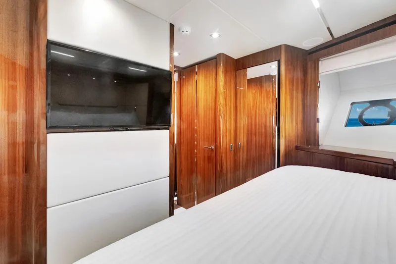 Slide: The Image of Luxurious cabin interior of 2017 Sunseeker 68 Sport Yacht with wood paneling and TV. - 33