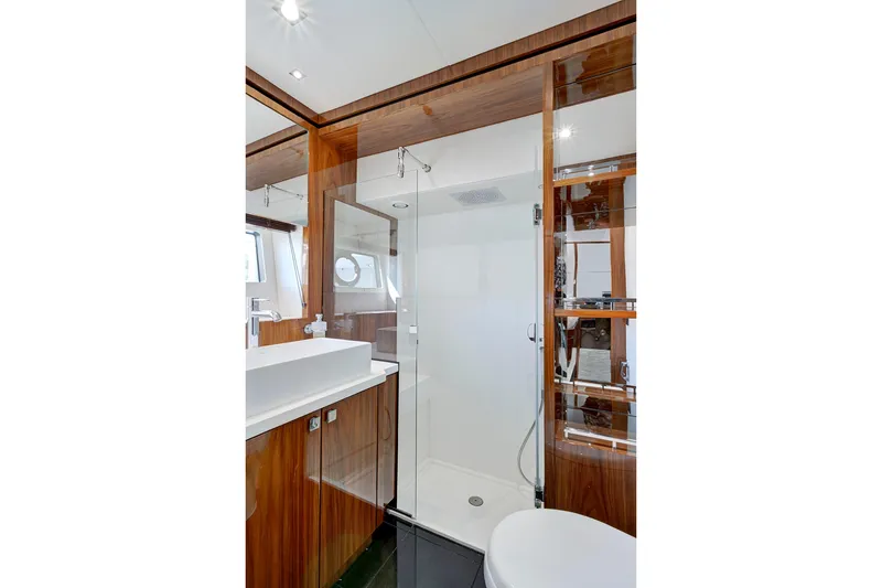 Slide: The Image of Luxurious bathroom in 2017 Sunseeker 68 Sport Yacht with modern fixtures and wooden accents. - 36