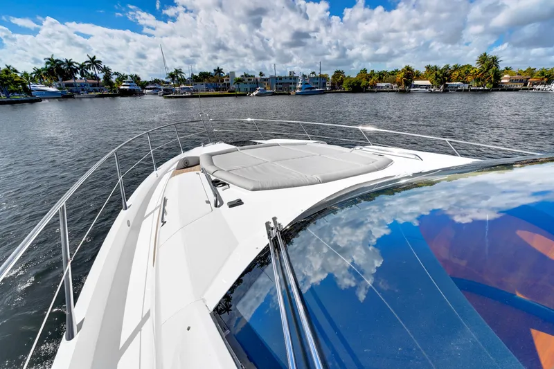 Slide: The Image of 2017 Sunseeker 68 Sport Yacht on water, sunny day, palm trees in background. - 5