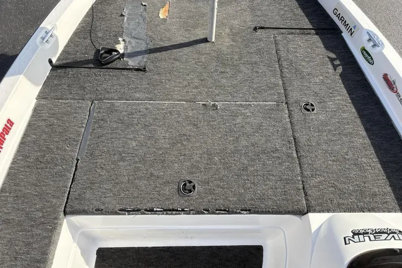 Slide: The Image of 1997 Javelin 400 SE boat deck with gray carpet and storage compartments. - 16