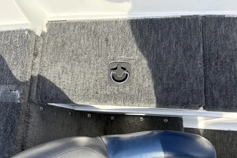 Slide: The Image of 1997 Javelin 400 SE boat interior with gray carpet and seat detail. - 19