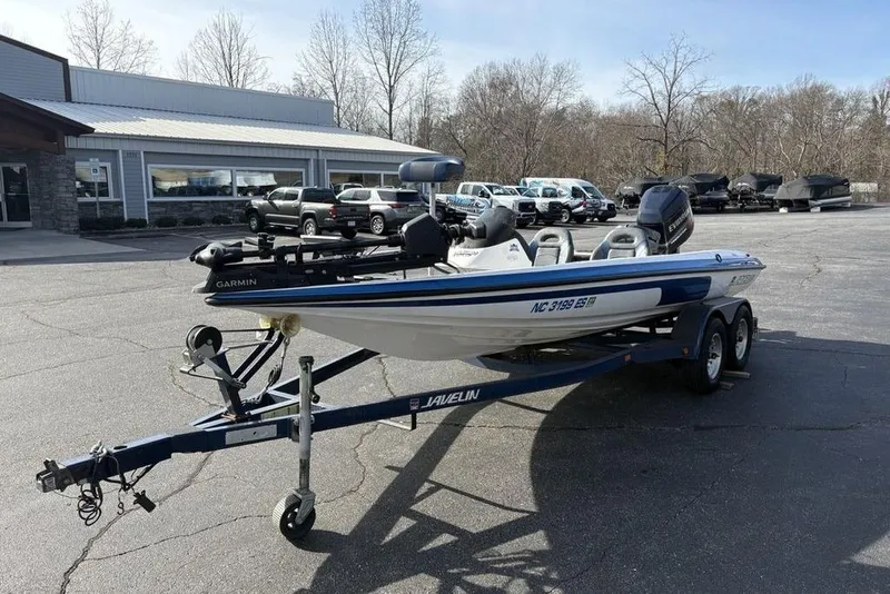 Slide: The Image of 1997 Javelin 400 SE boat on trailer in parking lot, clear day. - 2
