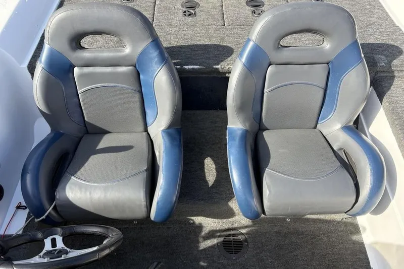 Slide: The Image of Two blue and gray seats in a 1997 Javelin 400 SE boat interior. - 21