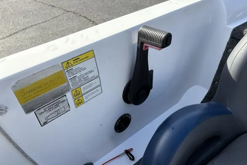 Slide: The Image of Interior of 1997 Javelin 400 SE boat showing capacity labels and seat. - 24