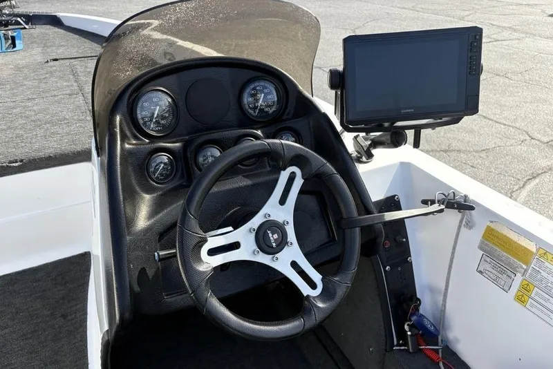Slide: The Image of 1997 Javelin 400 SE boat dashboard with steering wheel and Garmin display. - 26