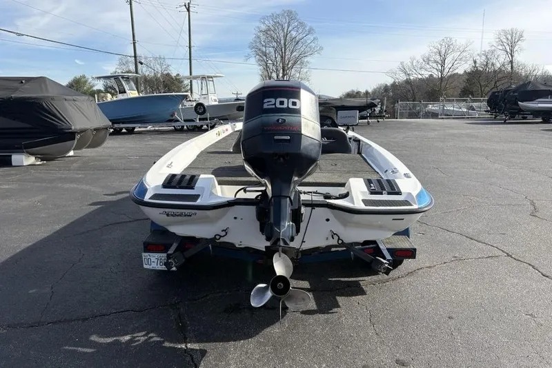 Slide: The Image of 1997 Javelin 400 SE boat with 200 HP motor in a parking lot. - 3