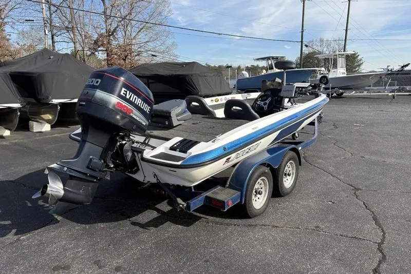 Slide: The Image of 1997 Javelin 400 SE boat with Evinrude motor on trailer in parking lot. - 4