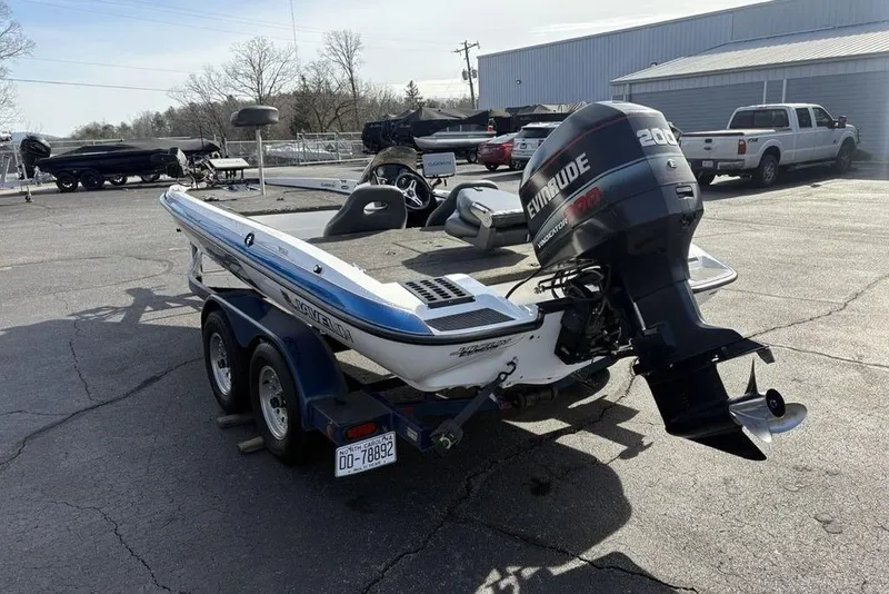 Slide: The Image of 1997 Javelin 400 SE boat with Evinrude motor on trailer in parking lot. - 8
