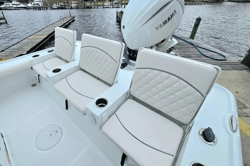 Slide: The Image of 2026 Sea Hunt BX 22 BR boat with cushioned seating and Yamaha engine at dock. - 13