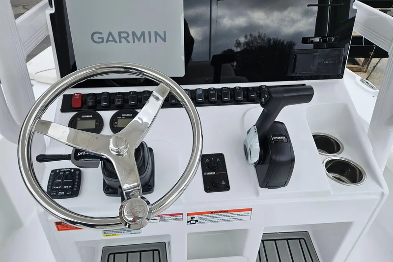 Slide: The Image of 2026 Sea Hunt BX 22 BR boat dashboard with Garmin display and Yamaha controls. - 19