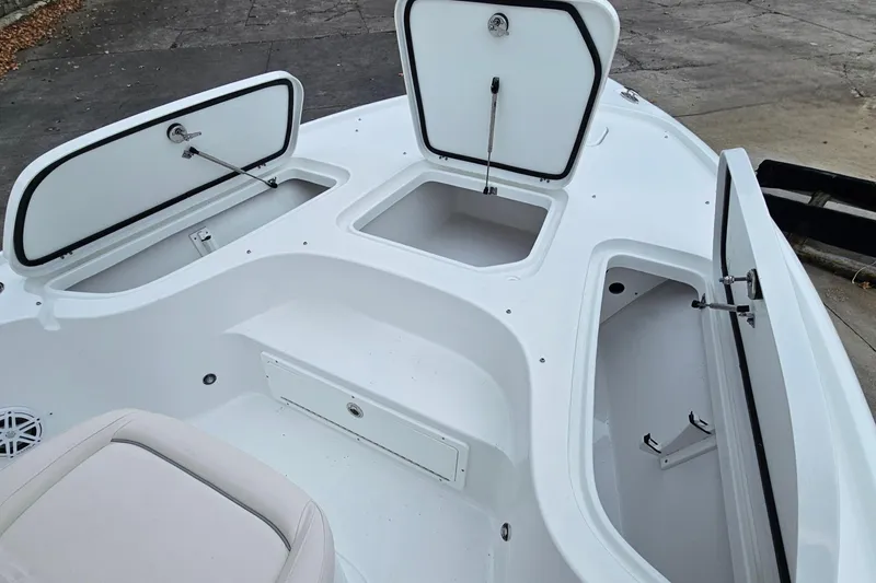 Slide: The Image of 2026 Sea Hunt BX 22 BR boat storage compartments open, showcasing spacious interior design. - 24