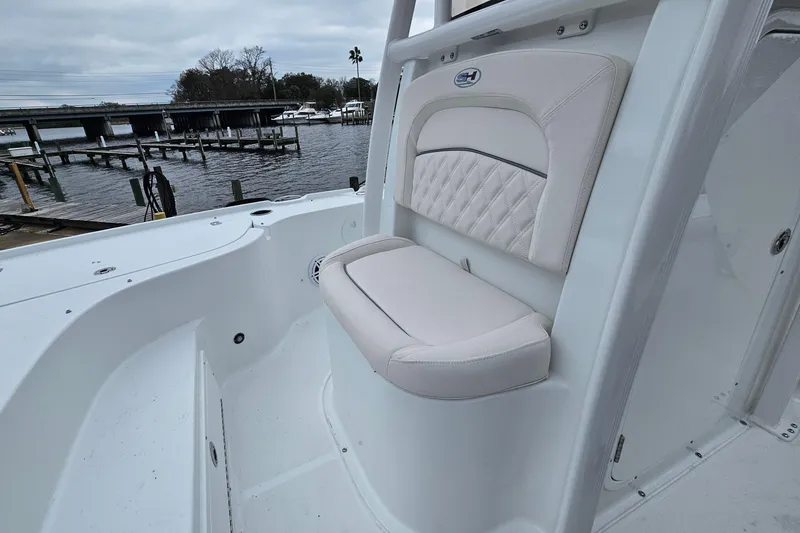 Slide: The Image of 2026 Sea Hunt BX 22 BR boat interior with cushioned seating by the water. - 26