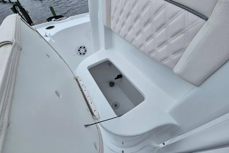 Slide: The Image of 2026 Sea Hunt BX 22 BR boat interior with cushioned seating and storage compartment. - 27
