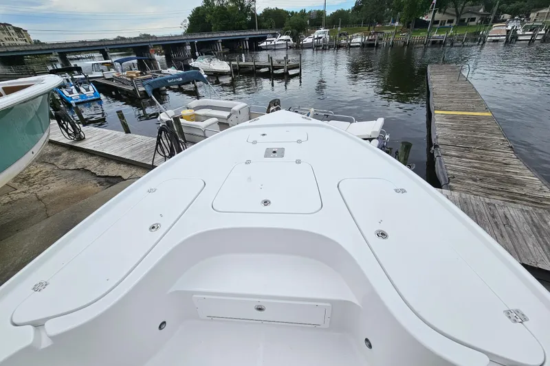 Slide: The Image of 2026 Sea Hunt BX 22 BR boat docked at a marina with surrounding watercraft. - 29