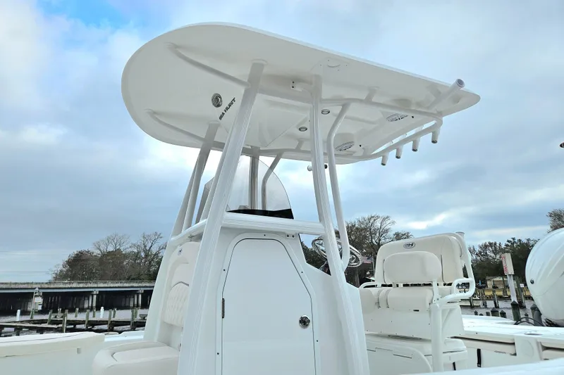 Slide: The Image of 2026 Sea Hunt BX 22 BR boat with T-top and seating, docked under cloudy sky. - 3