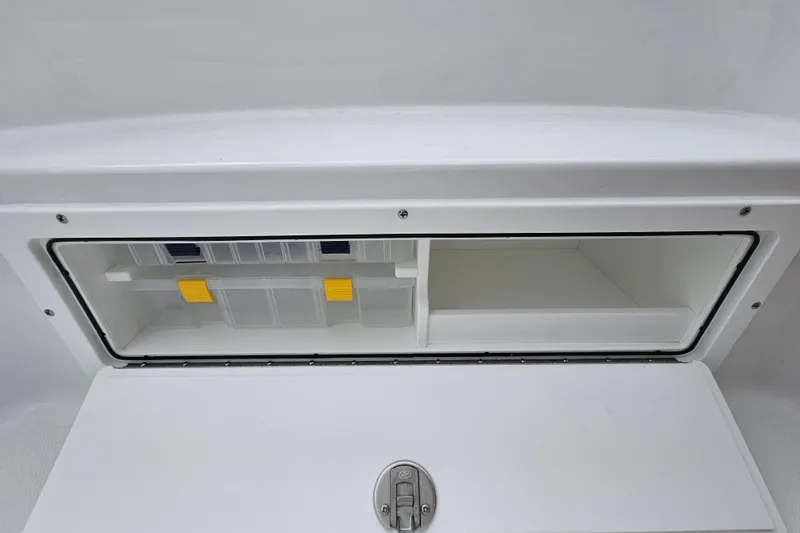 Slide: The Image of Storage compartment of 2026 Sea Hunt BX 22 BR boat, featuring organized sections. - 30