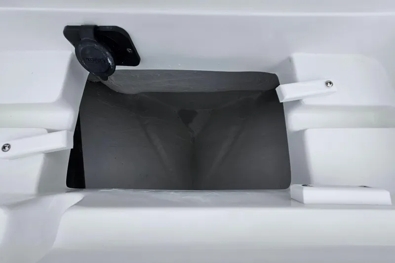 Slide: The Image of 2026 Sea Hunt BX 22 BR boat compartment with black lid and white interior. - 32