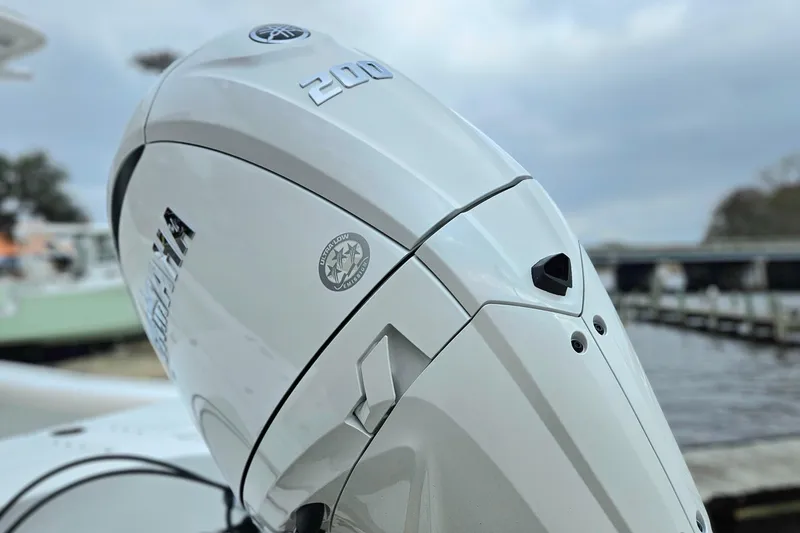 Slide: The Image of 2026 Sea Hunt BX 22 BR boat with Yamaha 200 outboard motor, docked by the water. - 4