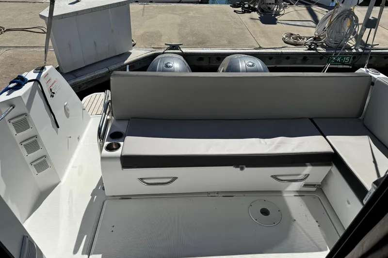 Slide: The Image of 2019 Jeanneau NC 895 boat interior with seating and twin outboard motors. - 20