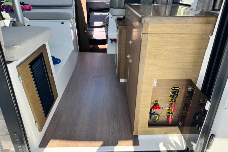 Slide: The Image of Interior view of 2019 Jeanneau NC 895 boat, featuring wood cabinetry and seating. - 26