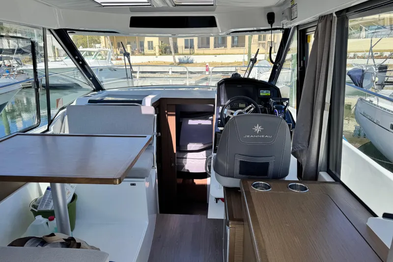 Slide: The Image of Interior of 2019 Jeanneau NC 895 boat with helm, seating, and table. - 27