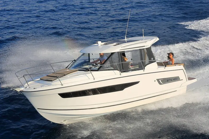 Slide: The Image of 2019 Jeanneau NC 895 cabin interior with cozy bed and wooden accents. - 3