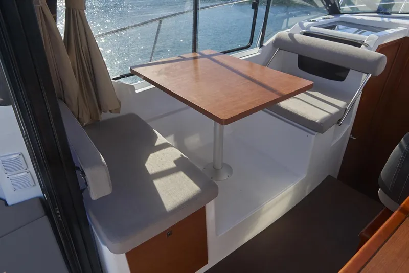 Slide: The Image of Interior view of 2019 Jeanneau NC 895 boat, featuring wood cabinetry and seating. - 8