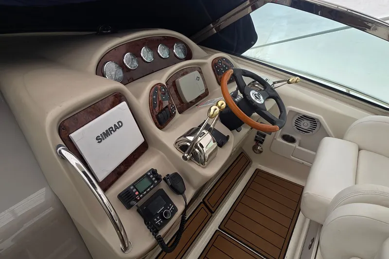Slide: The Image of 2007 Sea Ray 340 Sundancer helm with Simrad electronics and wood-accented steering wheel. - 10