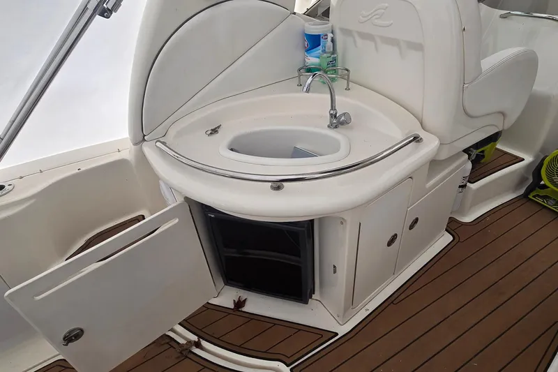 Slide: The Image of 2007 Sea Ray 340 Sundancer boat interior with sink and storage on teak deck. - 11
