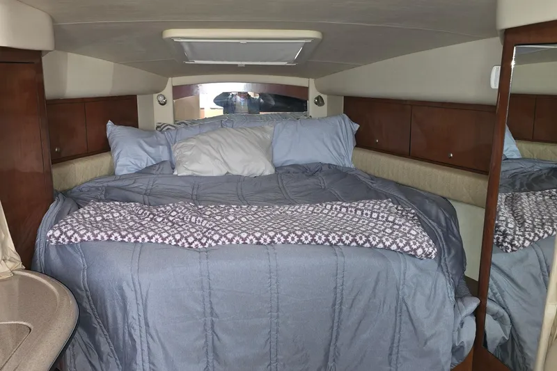 Slide: The Image of Cozy cabin interior of 2007 Sea Ray 340 Sundancer with comfortable bedding. - 12