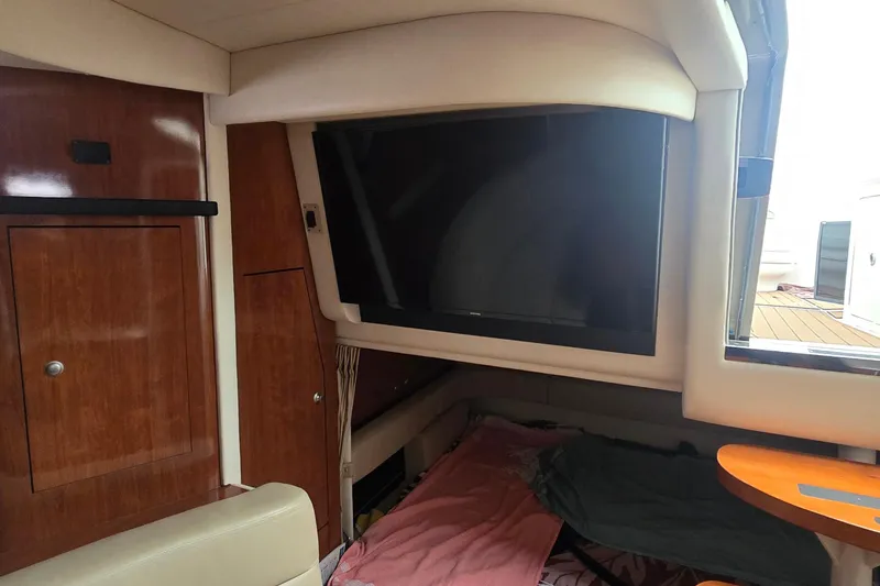 Slide: The Image of Interior of 2007 Sea Ray 340 Sundancer with TV and wooden cabinetry. - 15