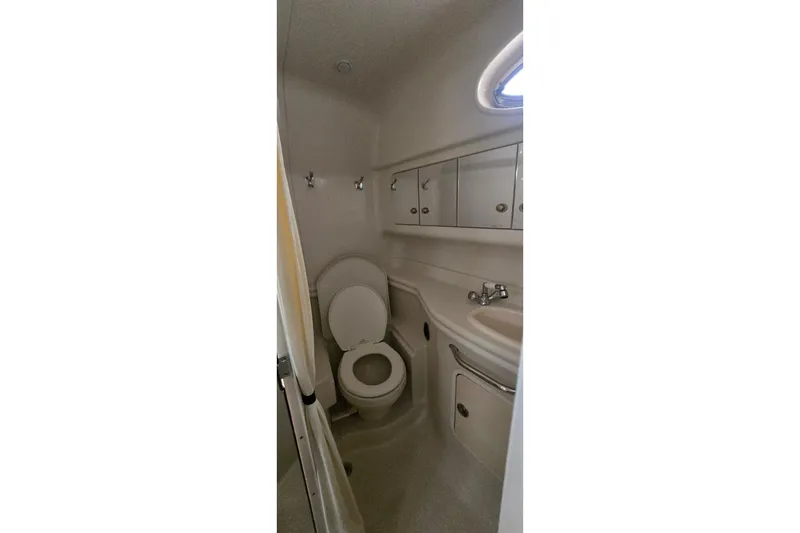 Slide: The Image of Bathroom interior of 2007 Sea Ray 340 Sundancer yacht, featuring toilet and sink. - 16