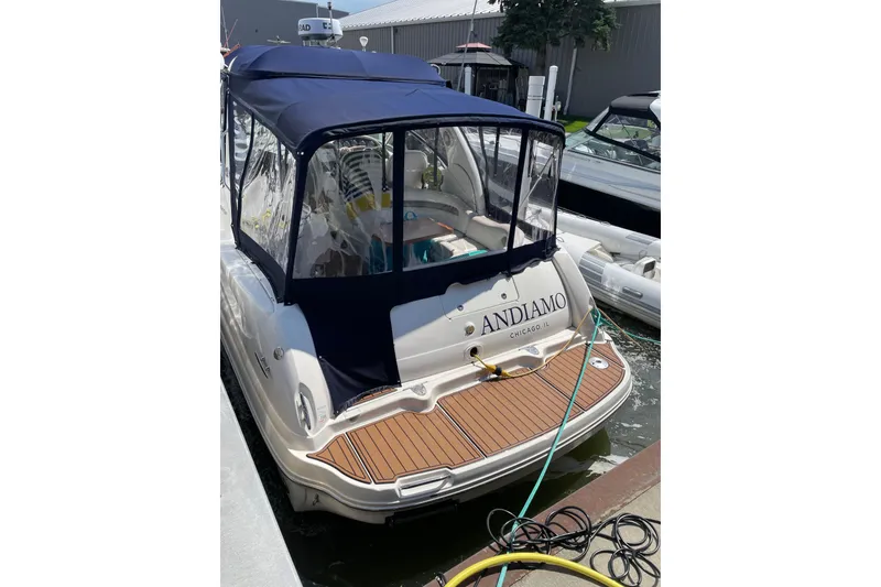 Slide: The Image of 2007 Sea Ray 340 Sundancer docked with blue canopy and wooden deck. - 3