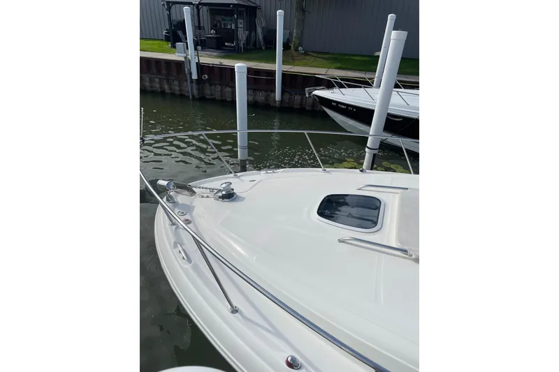Slide: The Image of 2007 Sea Ray 340 Sundancer docked, showcasing sleek bow design and water reflections. - 4