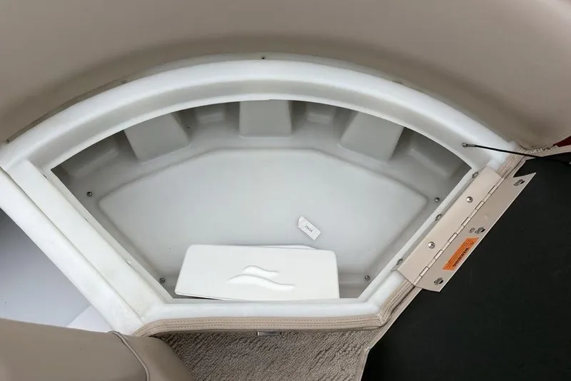Slide: The Image of Storage compartment in 2013 Berkshire 233 RFX STS boat, featuring beige interior and secure latch. - 16