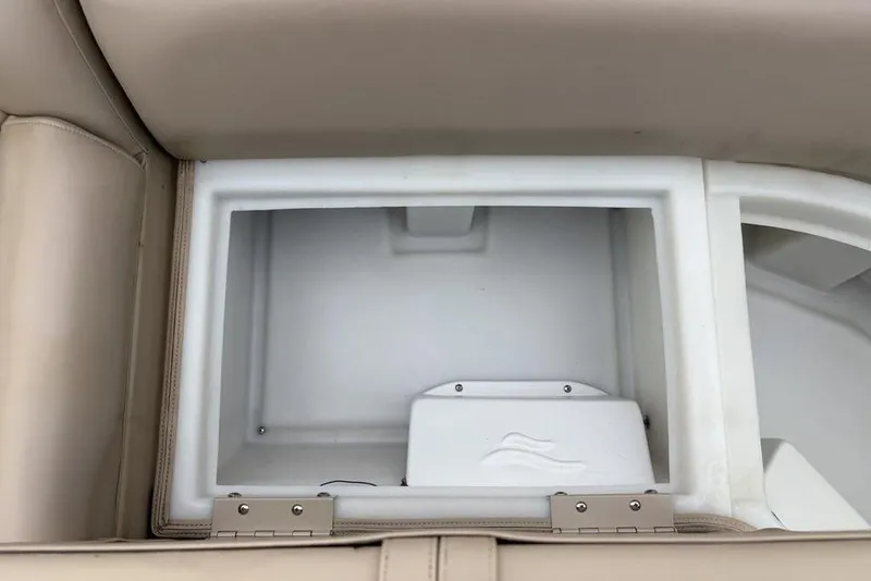 Slide: The Image of 2013 Berkshire 233 RFX STS boat storage compartment with beige upholstery. - 17