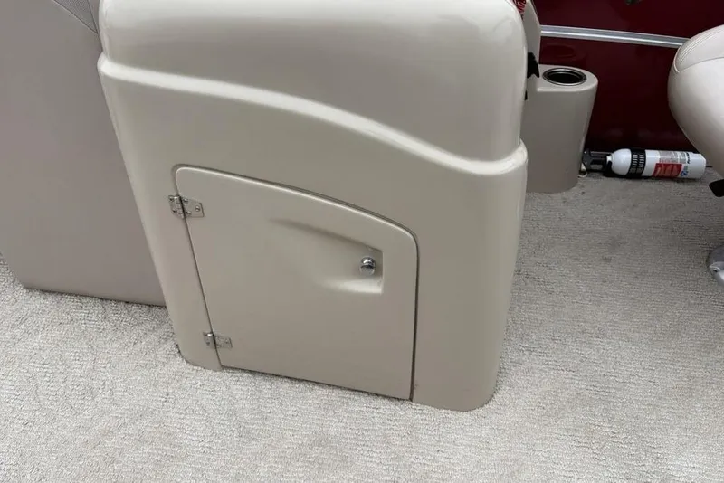 Slide: The Image of 2013 Berkshire 233 RFX STS boat interior with beige storage compartment and fire extinguisher. - 18