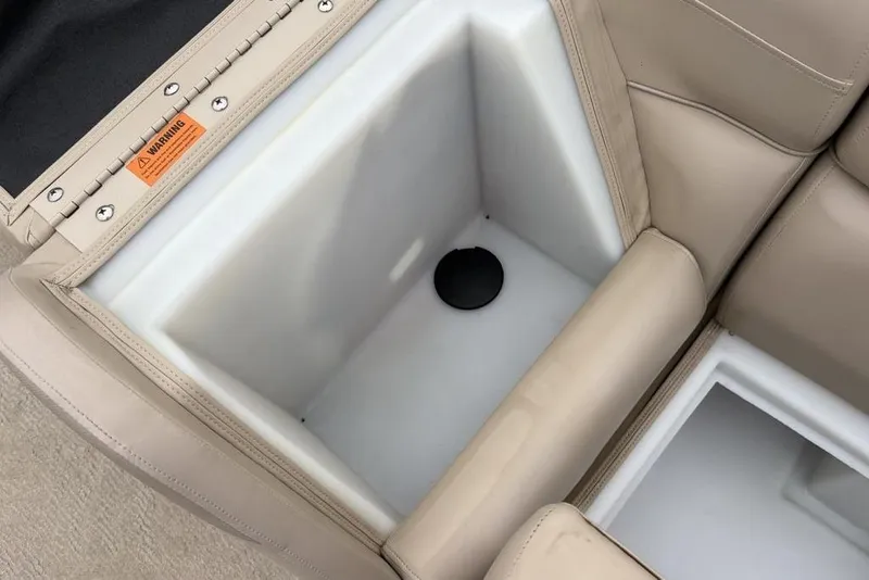 Slide: The Image of Storage compartment in a 2013 Berkshire 233 RFX STS boat with beige seating. - 19