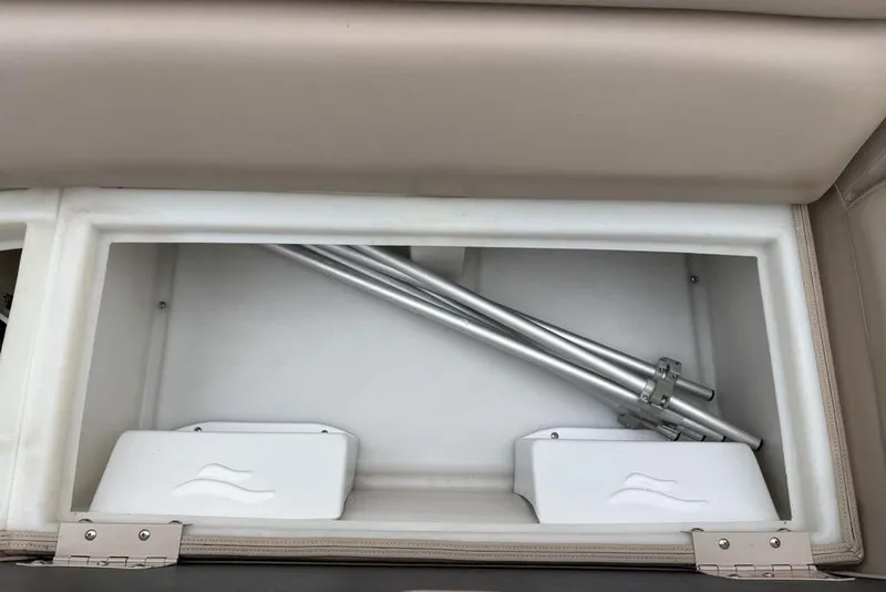 Slide: The Image of Storage compartment in a 2013 Berkshire 233 RFX STS boat with metal poles inside. - 32