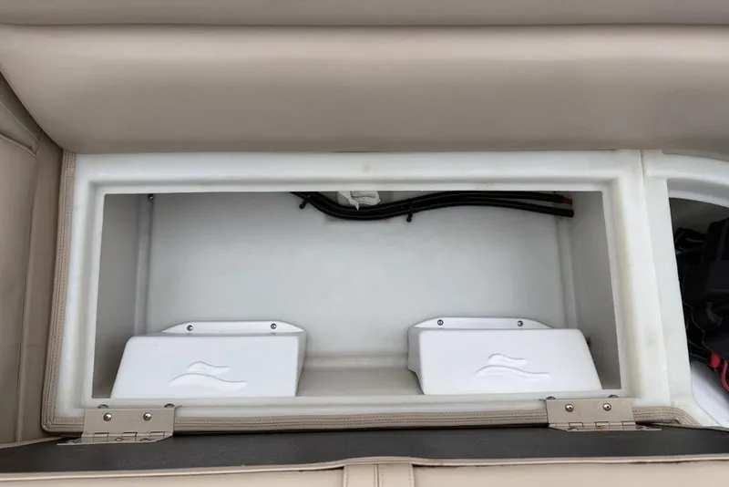 Slide: The Image of Storage compartment in a 2013 Berkshire 233 RFX STS boat, featuring beige upholstery. - 39