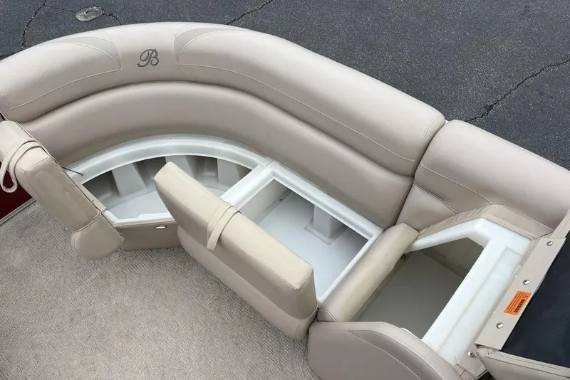 Slide: The Image of 2013 Berkshire 233 RFX STS boat seating with storage compartments, beige upholstery. - 5