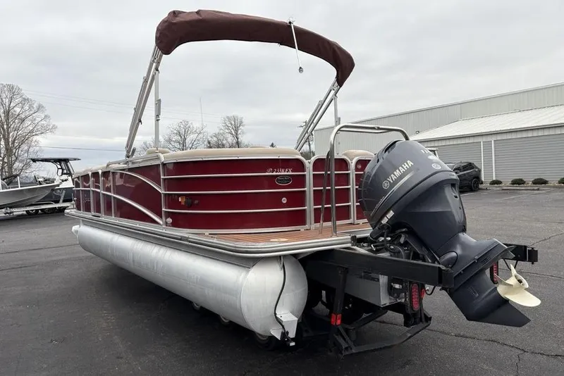 Slide: The Image of 2013 Berkshire 233 RFX STS pontoon boat with Yamaha outboard motor, parked outdoors. - 8