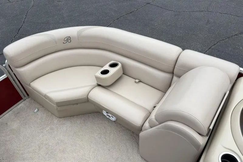 Slide: The Image of Luxurious seating on 2013 Berkshire 233 RFX STS pontoon boat with beige upholstery and cup holders. - 9