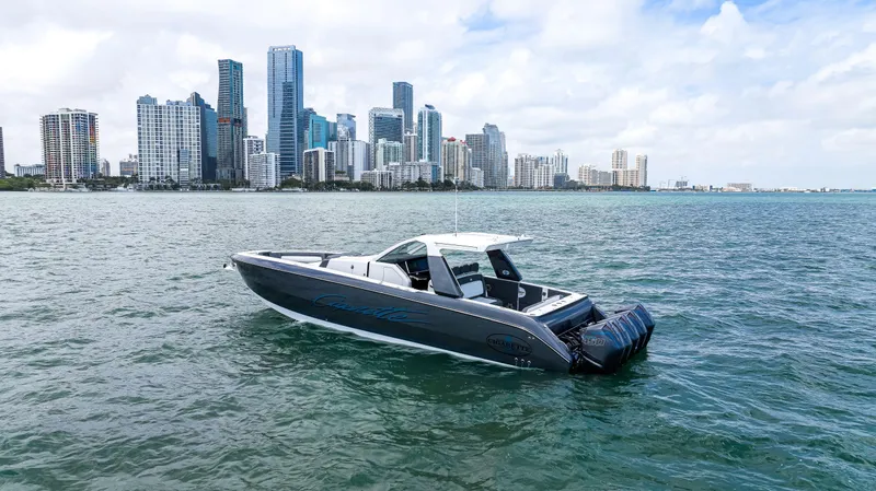 Slide: The Image of 2022 Cigarette 42 Auroris boat on water with city skyline in background. - 11