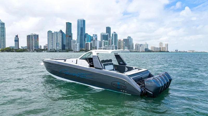 Slide: The Image of 2022 Cigarette 42 Auroris boat on water with city skyline in background. - 12