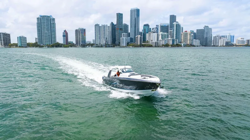 Slide: The Image of Cigarette 42 Auroris 2022 speedboat cruising near city skyline on a sunny day. - 14