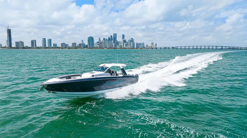 Slide: The Image of Cigarette 42 Auroris 2022 speedboat cruising on turquoise waters near city skyline. - 15
